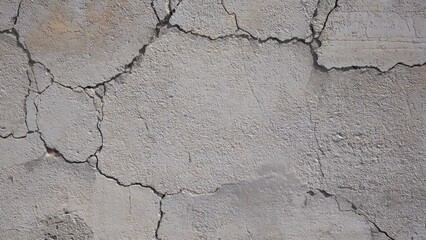 Obraz premium Cracked wall with rough texture. Grey tone and damaged surface creating natural abstract pattern