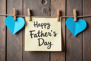 fathers day card hanging on a clothesline with blue hearts