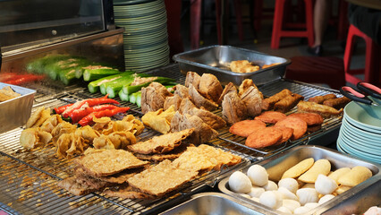 a display of Yong Tau Foo, a Hakka Chinese dish popular in Southeast Asia. it consists of various ingredients, primarily tofu, stuffed with a ground meat mixture or fish paste. hawker stall in KL