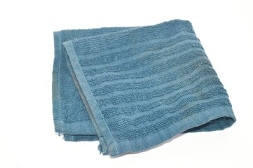 Blue folded fabric napkin on white background, copy space, space for text