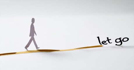 Paper figure walks toward words let go. Minimalist concept, white background, symbolic representation of release, acceptance, transition.
