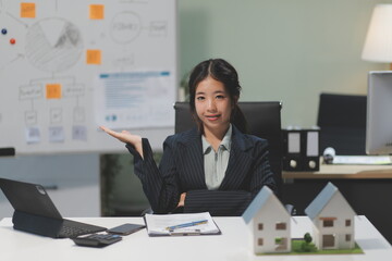 Real estate agents explain models of housing estates in projects to elaborate to clients,...
