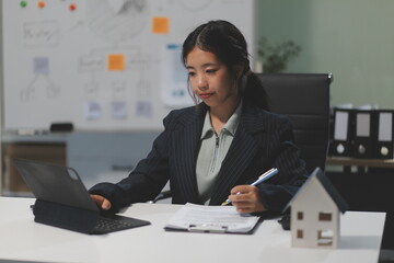 Real estate agents explain models of housing estates in projects to elaborate to clients,...