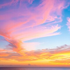 Fototapeta premium A breathtaking sunset paints the sky in vibrant shades of pink and orange, with wispy clouds softly illuminated, creating a serene and magical atmosphere.