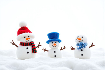 three snowmen wearing hats and scarfs in the snow