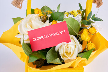 A vibrant display of flowers in a bright basket showcases the beauty of nature. A card with the...