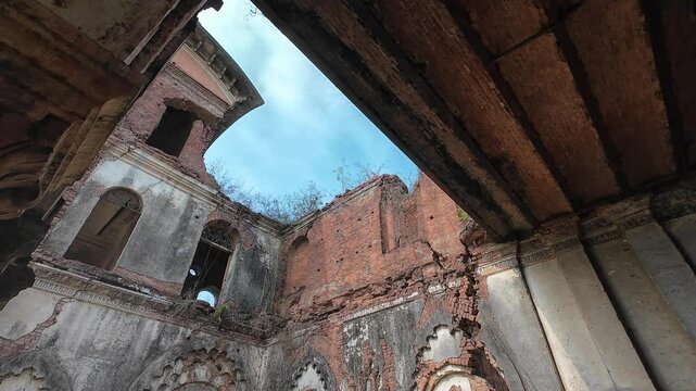 Ancient palace ruins with intricate carvings and weathered brick architecture overgrown with vegetation, Rajnagar palatial complex, Rajnagar, Bihar, India