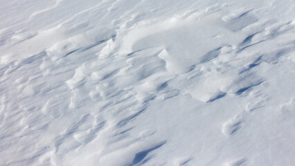 The snow is white and the ground is covered in it