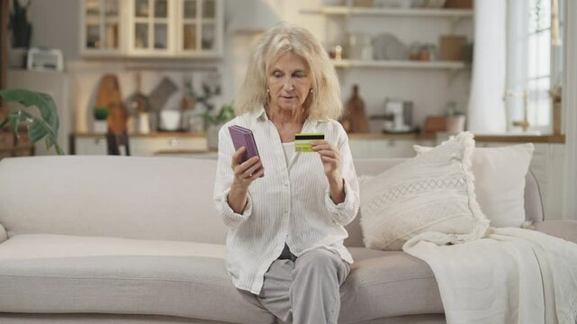 Data theft and fraud with credit card, aged woman talking with scammers by phone . Portrait of mature lady reporting data of bank card, feel shock and frustration, emotional grandmother, money steal