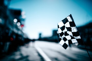 close-up of a black and white checkered flag on a racetrack