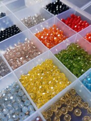Colorful vibrant crystal beads organized in plastic compartment box
