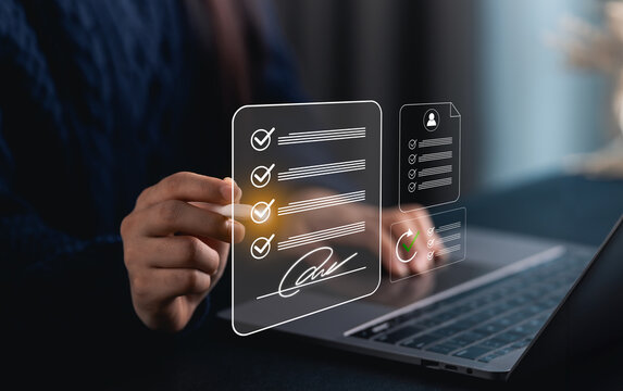 Close-up hand woman reviews a digital document on a laptop, holding a digital pen to add a signature, emphasizing modern technology and efficient workflows in office settings.