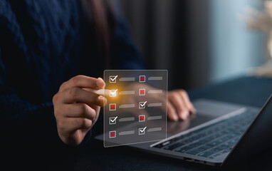 Close-up hand woman using digital checklist on laptop while managing tasks and projects for...