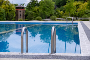Stainless steel stairs in resort swimming pool