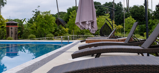 Sun bed chair on the edge of a hotel or resort swimming pool