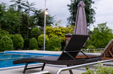 Sun bed chair on the edge of a hotel or resort swimming pool