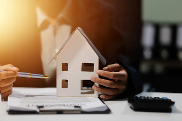Real estate agents explain models of housing estates in projects to elaborate to clients,...