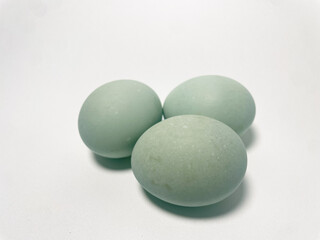 Close up photo of salted duck eggs with white background.