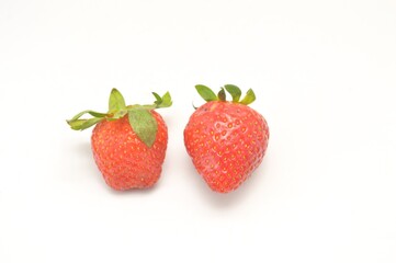 Close up view of strawberry harvest held in hand on white background. Concept of healthy food, vitamins, agriculture, market, sale of strawberries.