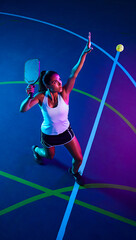 Dynamic Female Pickleball Player Serving with Power and Precision on Vibrant Court