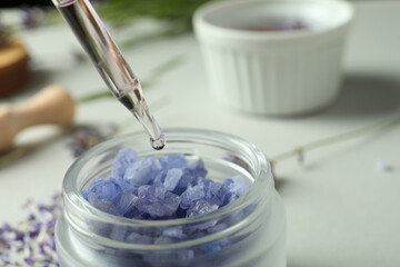 A dropper with lavender oil and a lavender flower close-up