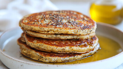 Pancakes stacked on top of each other with a drizzle of honey