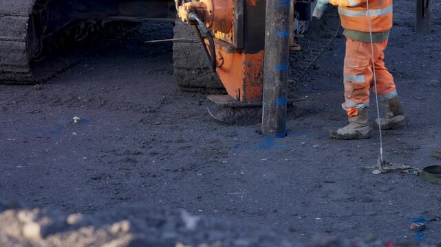 Piling rig heavy machinery hammering piles down into ground for  future building foundation