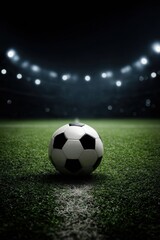 Naklejka premium Soccer Ball on Field with Stadium Lights in Background at Night