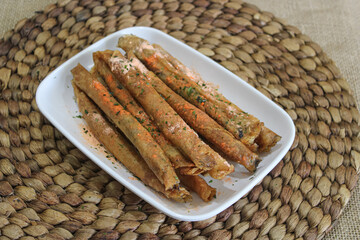 a plate of crispy caramel roll snacks