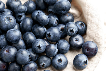 Juicy blueberries on crumpled cloth napkin. Ripe nutritious superfood berry