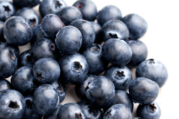 Juicy blueberries in kitchen bowl on table with fabric tablecloth. Ripe nutritious berry superfood. 