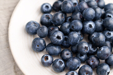 Freshly picked blueberries on a kitchen plate. Organic bilberry. Top View. 