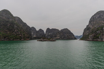 Halong Ha Long Bay Hanoi this Vietnamese wonder is littered with mountains and Rock cliffs popping out of the ocean, lush green mountains in Vietnam