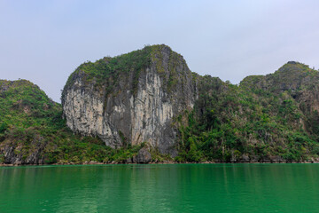 Halong Ha Long Bay Hanoi this Vietnamese wonder is littered with mountains and Rock cliffs popping out of the ocean, lush green mountains in Vietnam