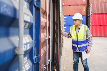 Customs clearance officer or shipyard engineer is inspects against the import - export cargo containers.