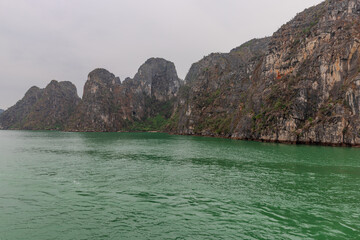 Halong Ha Long Bay Hanoi this Vietnamese wonder is littered with mountains and Rock cliffs popping out of the ocean, lush green mountains in Vietnam