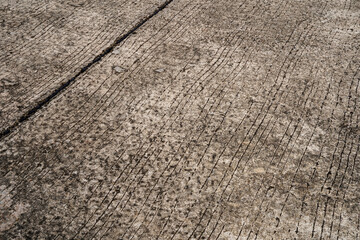 The concrete cement floor has cut lines.
