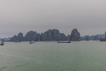 Halong Ha Long Bay Hanoi this Vietnamese wonder is littered with mountains and Rock cliffs popping out of the ocean, lush green mountains in Vietnam