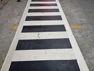 Pedestrian crosswalk with black and white stripes