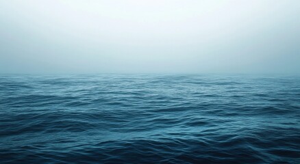 Fototapeta premium Moody Dark Blue Ocean Under Misty Light Blue Sky