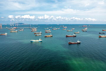 Aerial view of numerous oil and gas tankers anchored in a bay, showcasing industrial-scale maritime energy transport and the density of commercial sea traffic.