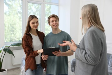 Real estate agent working with couple at home