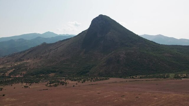 A drone over fields and mountains near Sibari, Italy. A cloudy summer day