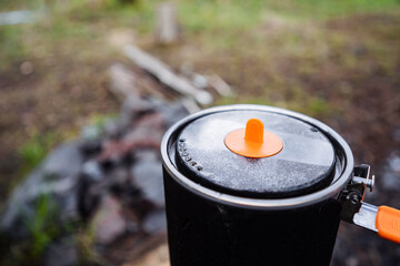CloseUp image showcasing a Camping Pot resting with its Lid securely placed, set against the...
