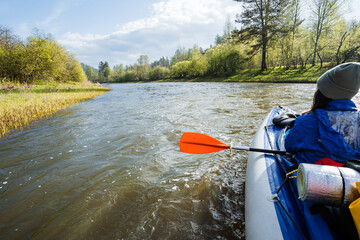Embark on an exciting kayaking adventure on a serene river surrounded by vibrant nature, perfect...