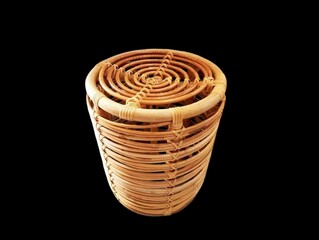 The Black  background in the picture is a woven chair made from rattan in a circular pattern It is delicate and solid and can support a lot of weight when sitting It has the toughness.