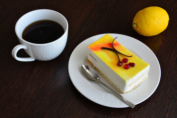 Coffee, cake and lemon on a wooden table