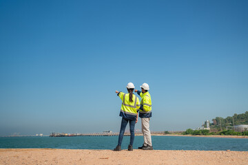 Team mechanical engineer working and holding tablet to checking and inspection gas pipeline system new construction project of industrial.
