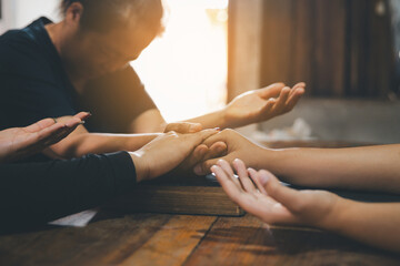 Praying religion, worship and group of people pray to God, Family, holding hands and prayer in home...