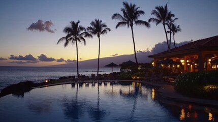 Fototapeta premium Night view of luxurious resort pool with ambient lighting, palm silhouettes, and oceanfront setting